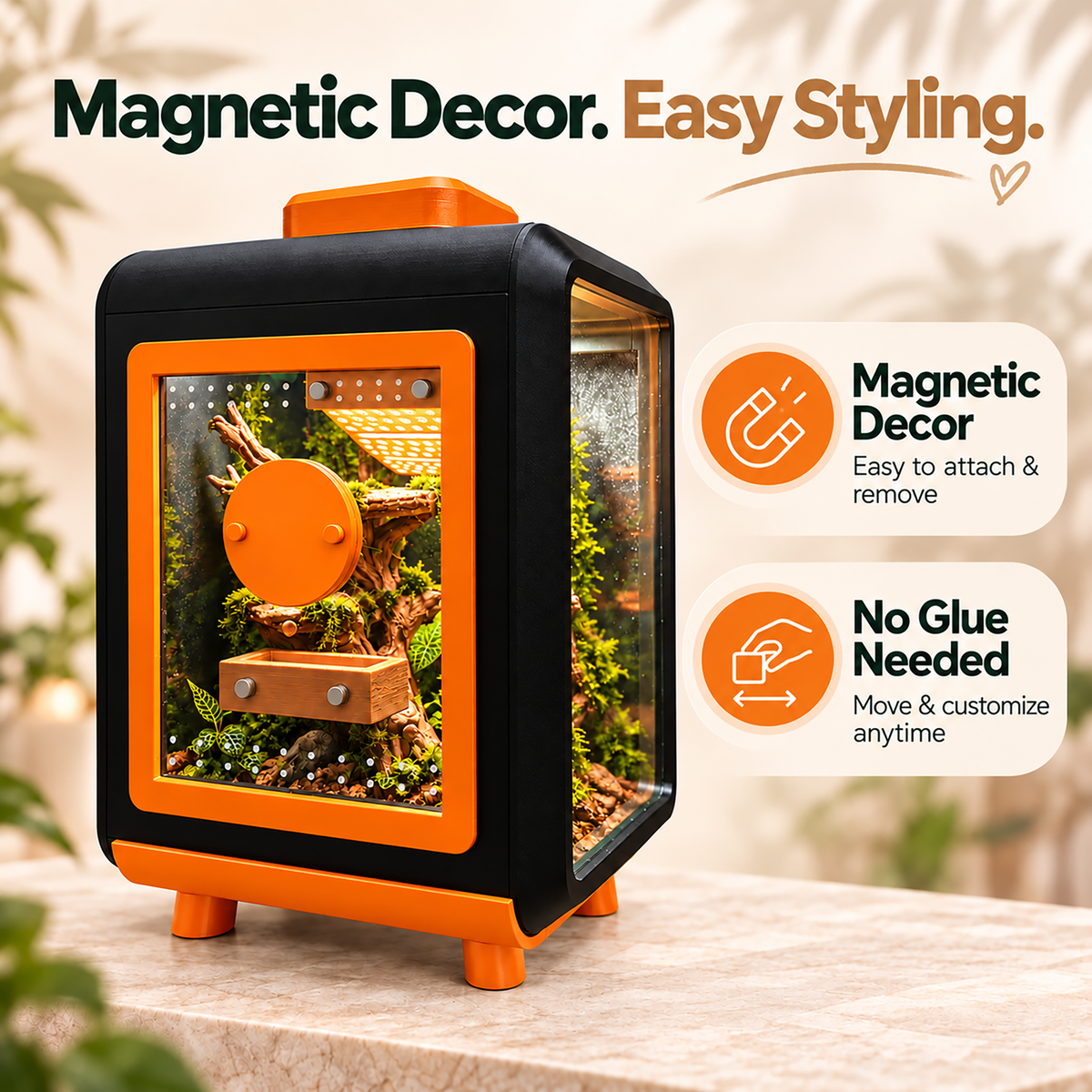 An orange and black magnetic pet terrarium with a acrylic front door, shown on a stone surface with promotional text and icons about easy styling and magnetic removability.